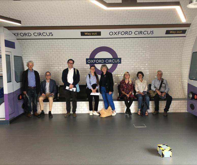 a group of people standing in a tube station