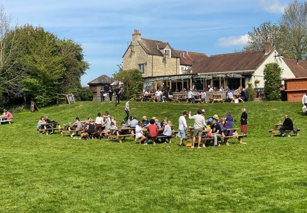 People sat in sunny Victoria Arms pub garden